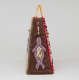 Side view of triangular brown leather bag with thin yellow handles, fur trim, and beaded tassels, featuring a red and blue beaded seal silhouette. 