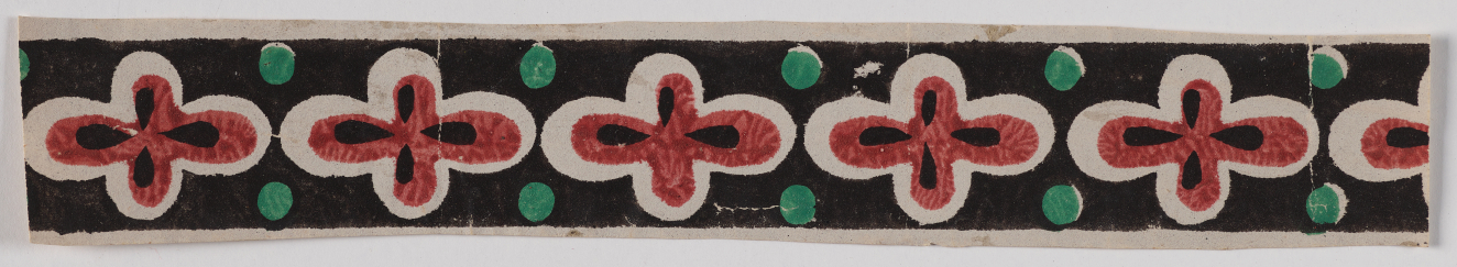 Black horizontal strip featuring a repeating pattern of red and white four petalled flowers with black accents flanked by green dots.
