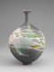 Different view of the same vessel covered in splashes of green and pink glaze.