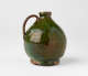 A short green bulbous jug with a tight rim, handle, and foot.