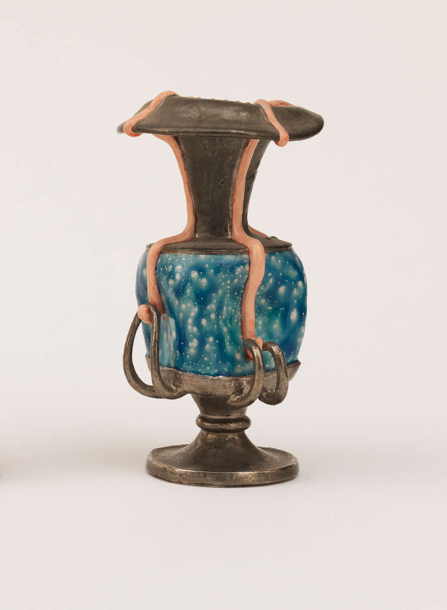 Tall ceramic urn with a metallic finish, wrapped around the center with a panel of bright, dappled blue and accented by pink stripes that curve around the body and handles.