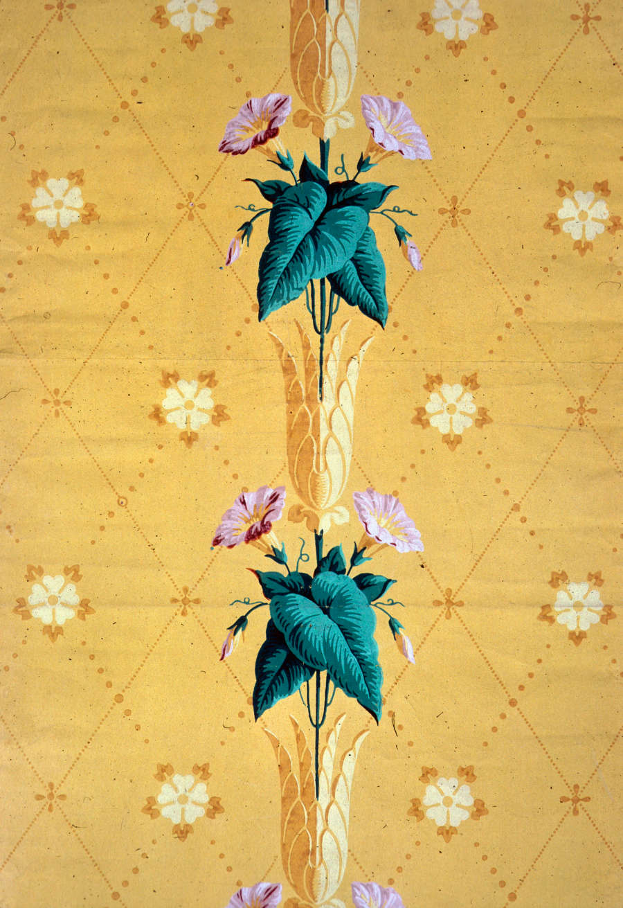 Delicate and surreal repeating ornamental column of leafy flower stalks emerging from the flowerbud of the stalk below it. The pattern repeats infinitely against a lattice-patterned yellow backdrop.