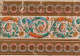 Ornate frieze of swirling acanthus leaves and florals between two rows of decorative borders in a vibrant palette of teal, orange, and brown.