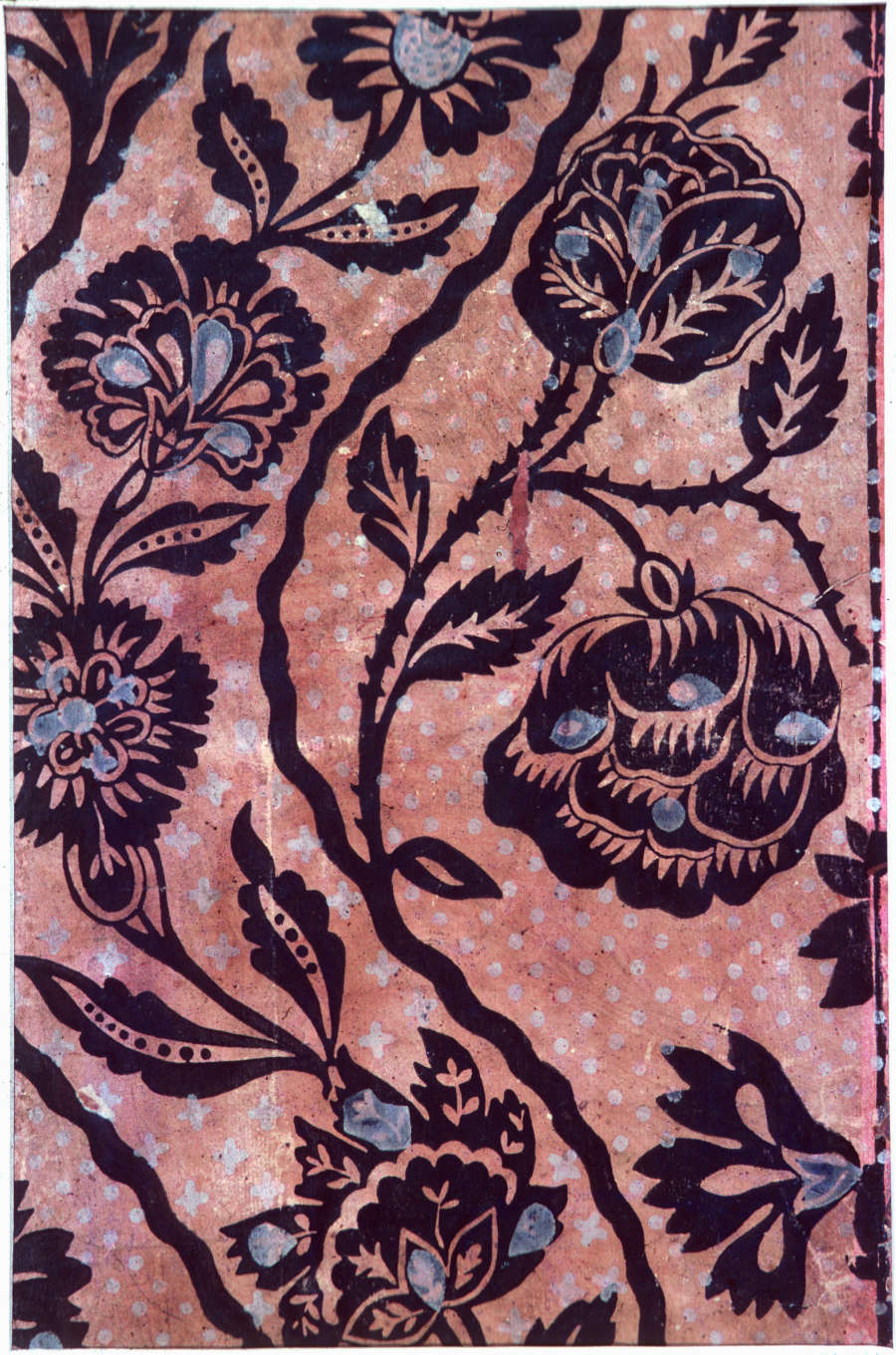 Segment of repetitive floral wallpaper depicting silhouetted chrysanthemums, curved vines and leaves set against a pink and white dotted background; blue accents decorate the motifs.