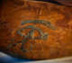 Close up of a hand-painted black eye motif on a wooden boat.