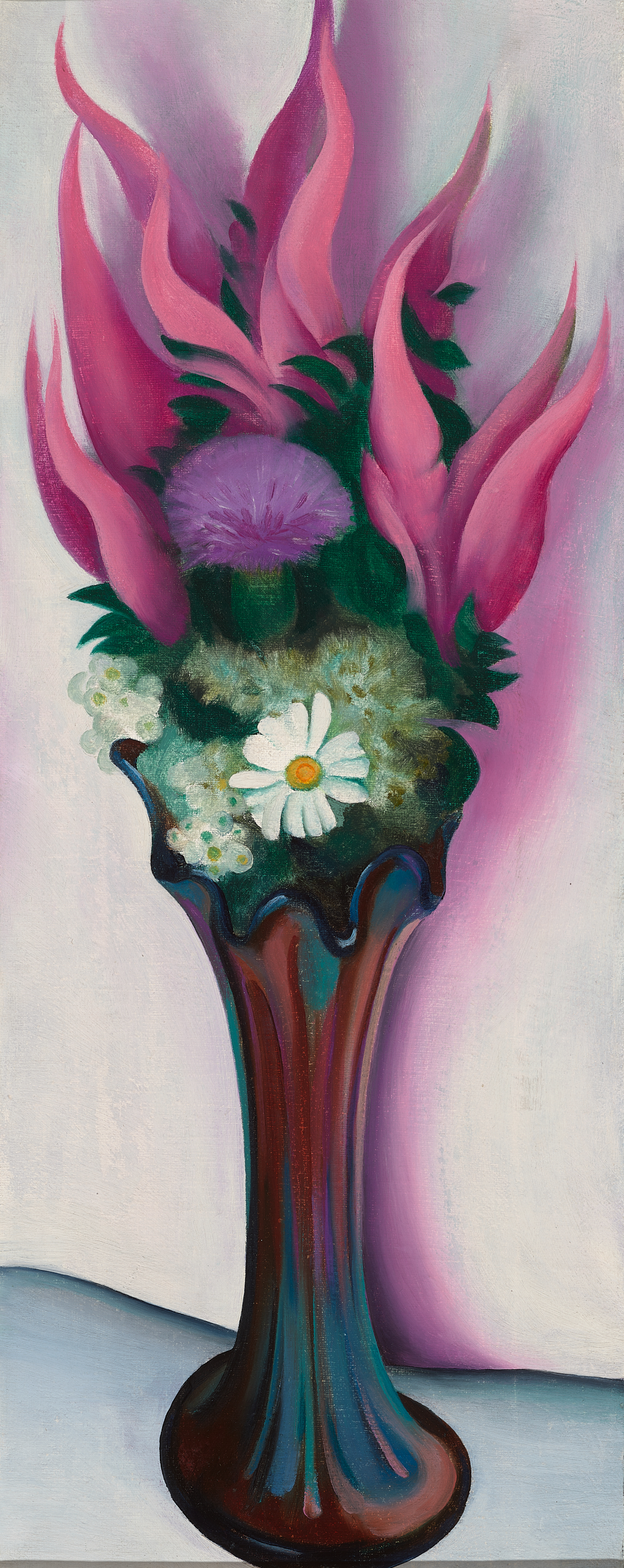 Tall, slender iridescent glass vase holding a bouquet of pink flame-like leaves rising upward, delicate white daisies, a purple flower, and green foliage.