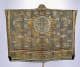 An intricately decorated gold garment with an elaborate pattern of flying cranes, floating clouds, and vibrant floral designs, centered around a medallion.