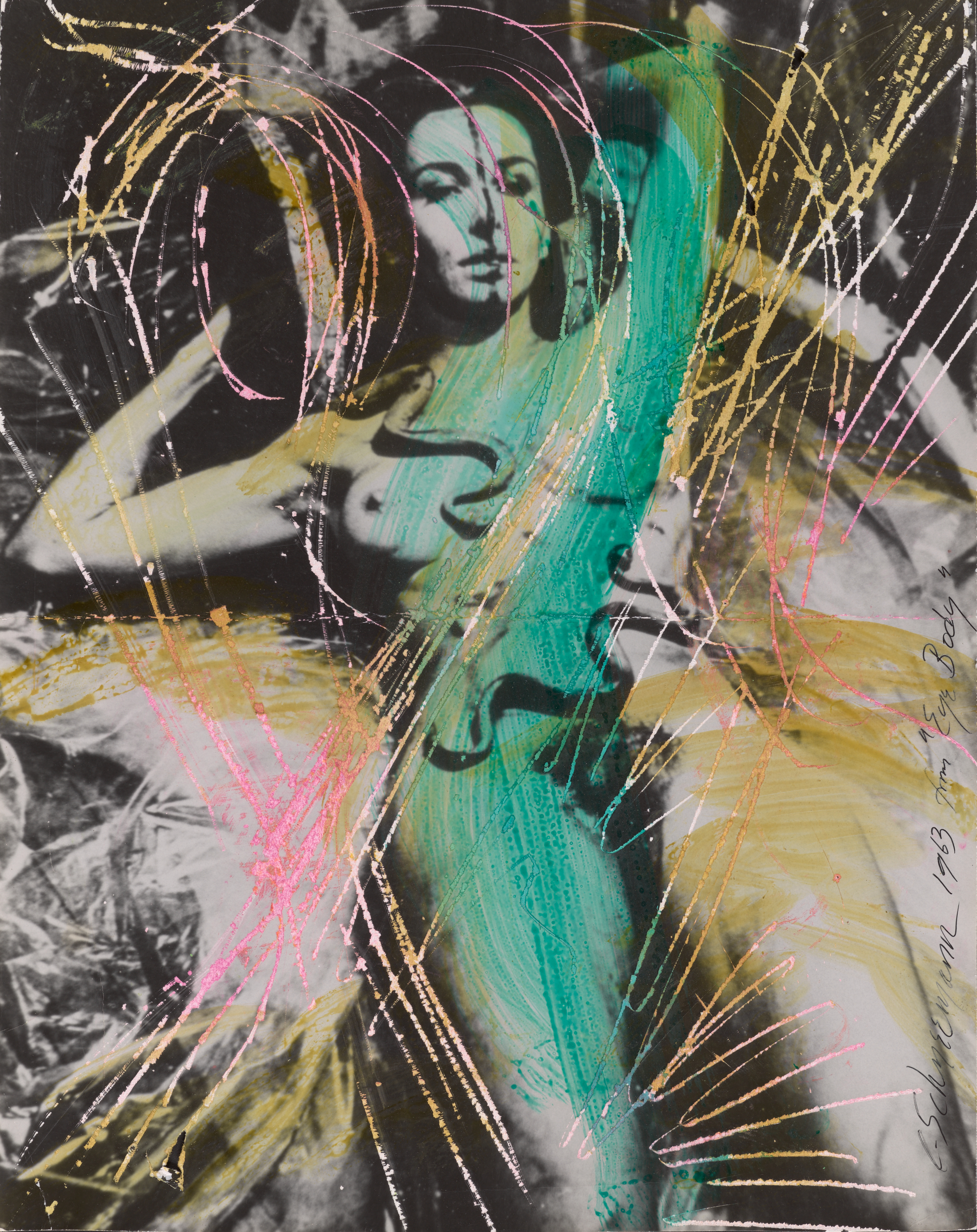 A black and white photograph of a relaxed, naked woman reclined with her hands behind her head and two snakes on her abdomen. The photograph is scratched and colored with yellow, green, and pink marker.