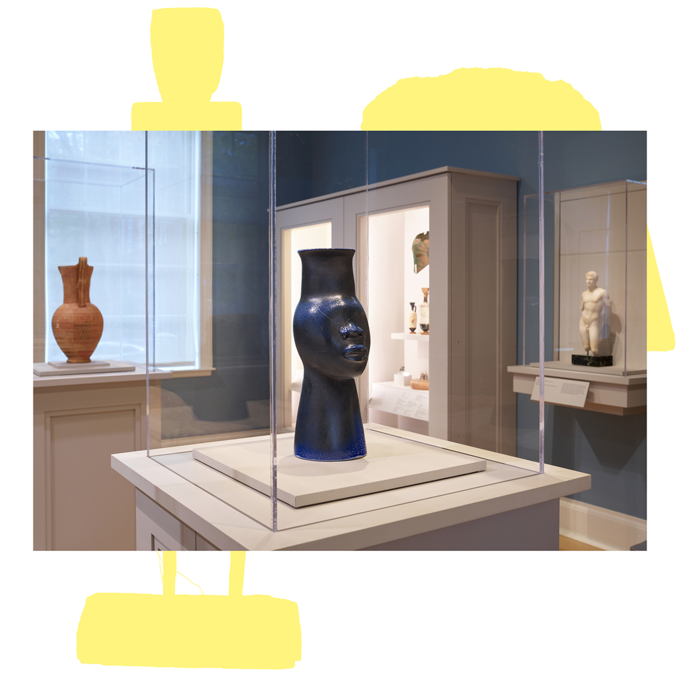 In a case in a gallery’s center is a sleek black vessel shaped like a stylized head with an elongated neck. Cases along the perimeter contain other objects.