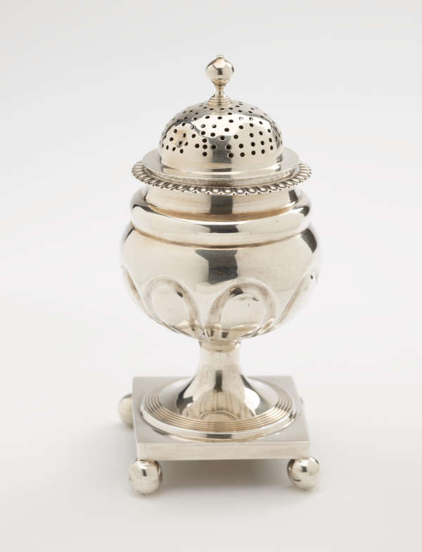  A silver caster with a square foot with small balls in each corner, the lid is perforated.
