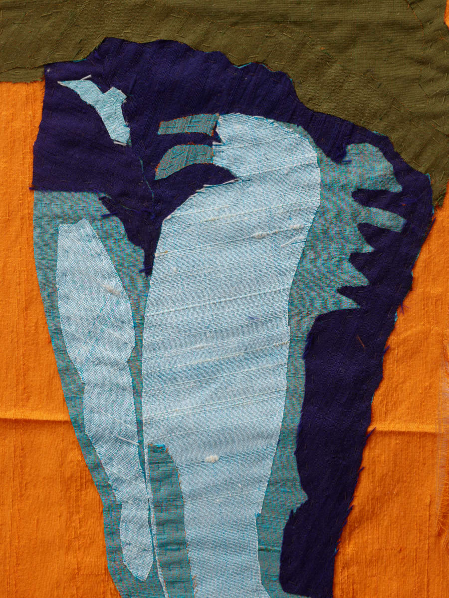 Textile of a detail of blue jeans at thighs against an orange background. The pants are contoured with large swaths of blue.