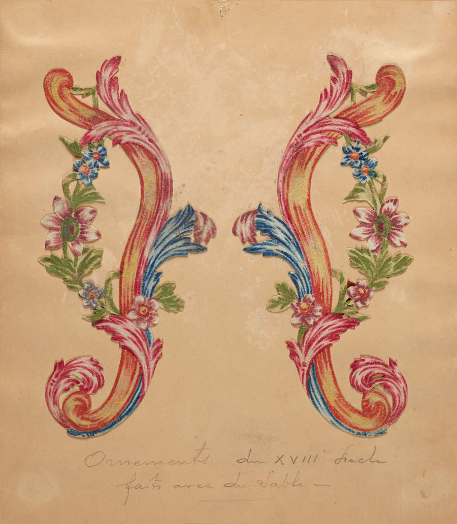 Tan paper with two mirror-image designs of green floral vines overtop layered red, yellow, and blue curved lines. Unreadable handwritten cursive text is below.