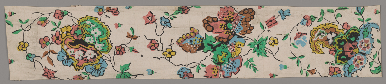 Thin stripe with intricate green, pink, yellow, and blue flowers and swirling vines and leaves on a light cream background.