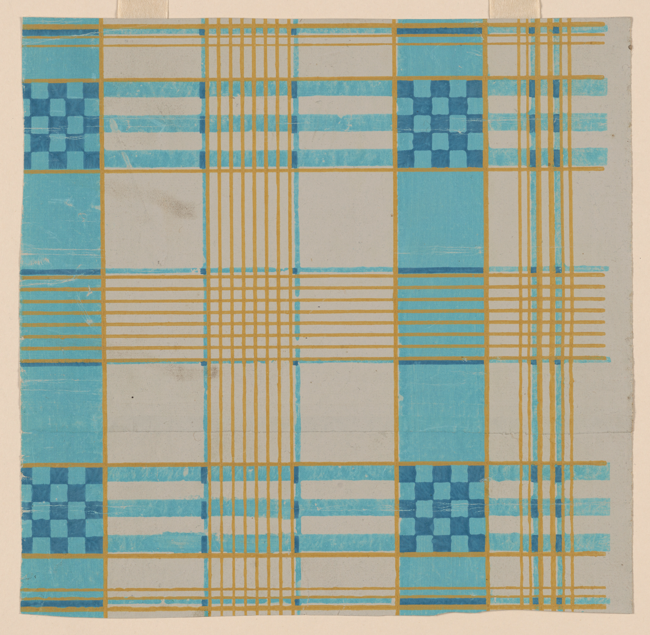 Cream wallpaper with a thin, yellow grid that is alternately filled in with thick transparent blue marker, creating an eccentric checkerboard pattern with variations in the center.