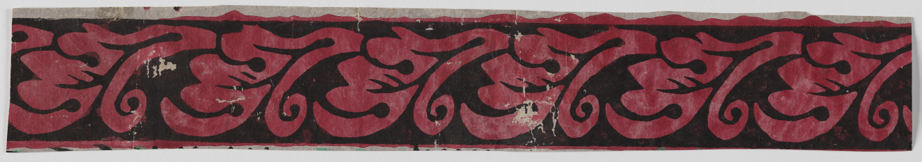 Decorative border featuring curling red foliage and scrollwork on a black background. The red paint shows aging and there is white chipping in the center.
