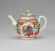 A white teapot with a handle, spout, lid and finial, with green, red, blue, pink, yellow and gilded decorations. The main vignite shows a dragon on a table.