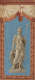 Tall, elegant depiction of an ancient warrior statue draped in robes standing proudly with a spear, framed within a decorative terracotta border against a sky-blue background.