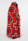 Side view photo of a red, patterned blanket wrapped around a mannequin against a white background. Smaller cross-shaped patterns line the mannequin’s sides with larger crosses in the center. 