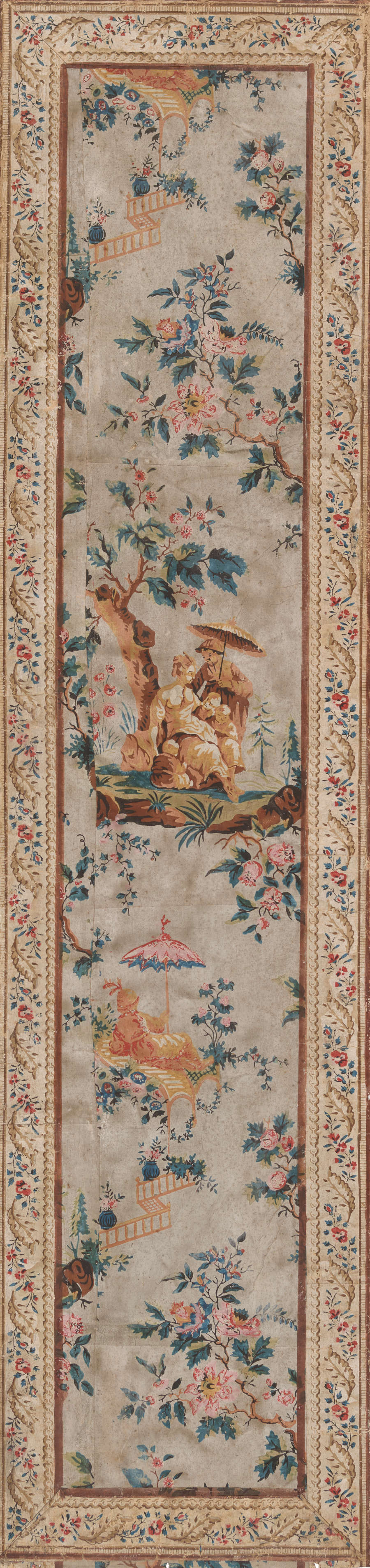 Tall, narrow panel of aged, elegant wallpaper featuring a central pastoral scene with surrounding floral patterns and ornate borders. The pattern is depicted in pastel colors against a beige background.