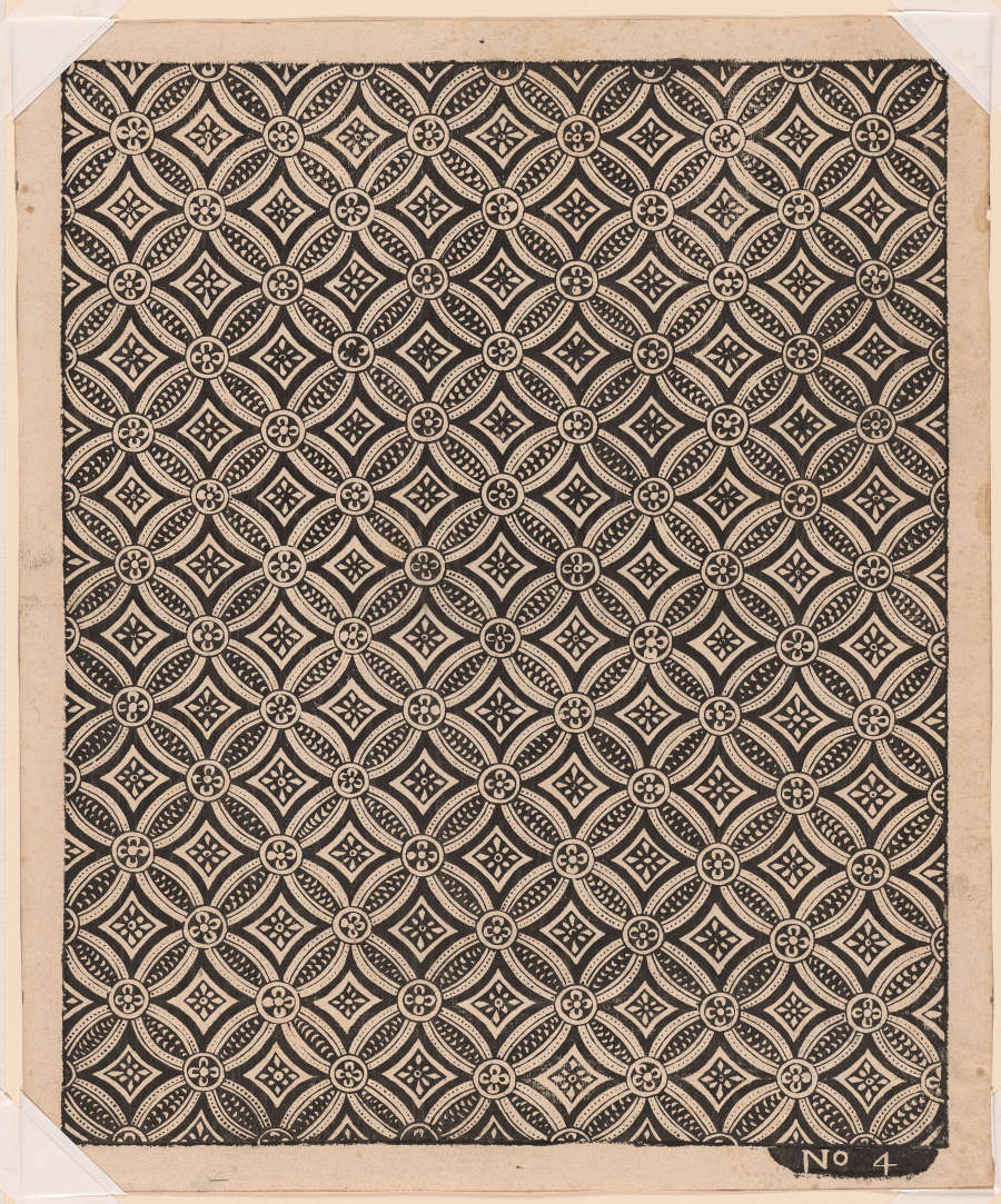 Segment of vintage geometric wallpaper depicting a black and white gridded pattern featuring diamond shapes and circular motifs arranged in a precise, repeating design.