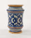 A jar with white, orange, and blue symmetrical decorations.