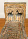 The foot end of a coffin, decorated with hieroglyphs and depictions of two black jackals seated on pedestals, facing each other.