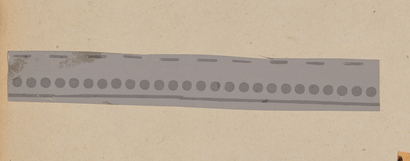 A horizontal strip with dark gray dots along the bottom edge set on a light gray background.