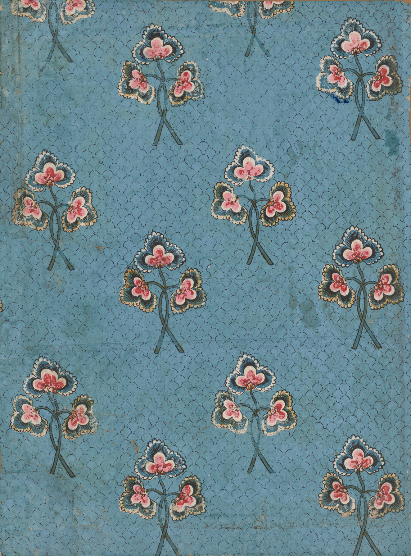 Vintage pattern featuring clusters of pink three-petaled flowers arranged in a diagonal grid on a mosaic-like teal backdrop.