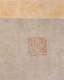 A faded red ink seal on textured grey paper beneath a pale orange border.