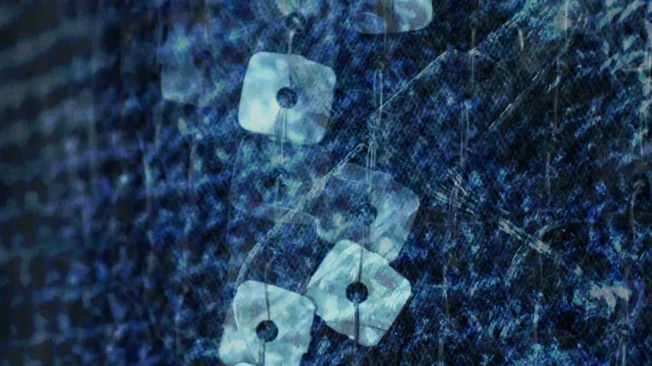 A dark abstract photograph of blue and black tones with light blue and translucent squares run through the center. The squares appear to be stitched to the background through holes in their centers.