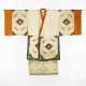 An elegant cream-colored robe with geometric floral embroidery and green trim, contrasted by orange bordered sleeves and neckline.
