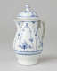 A white chocolate pot with delicate blue decorations with ribbed body, spout, handle, and foot.