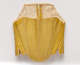  Photo of the back of a stitched gold-colored garment. Constructed of many panels, it is scalloped at the bottom.