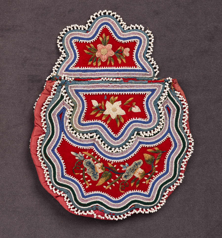 Beaded bag with its flap partially open, featuring wavy green, blue, and cream stripes framing a red body and top, both of which feature detailed green and white floral embroidery.