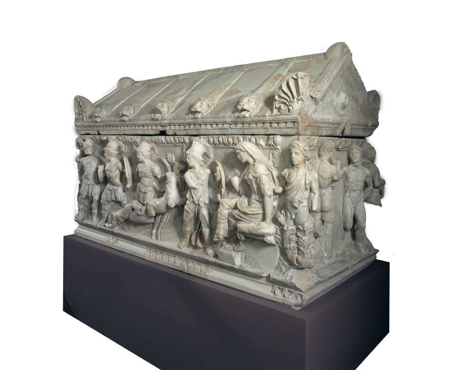 A deep-set, carved marble coffin adorned by a narrative with a seated central figure, and several mourning figures.