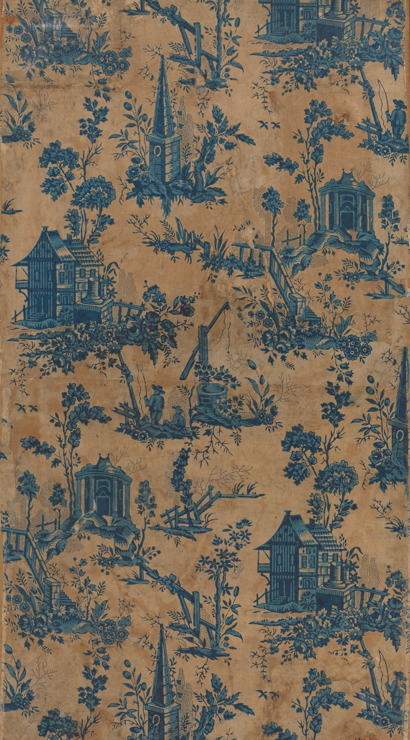 Panel of elegant, vintage wallpaper featuring a pattern of blue pastoral scenes of houses and churches with interspersed foliage motifs, on a distressed brown background.