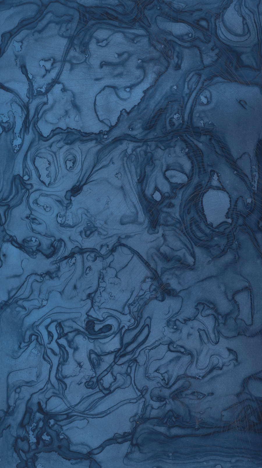 Dark, marble-like washes of ink fill the entirety of an indigo-dyed sheet of paper. The left side is a lighter blue than the right. 