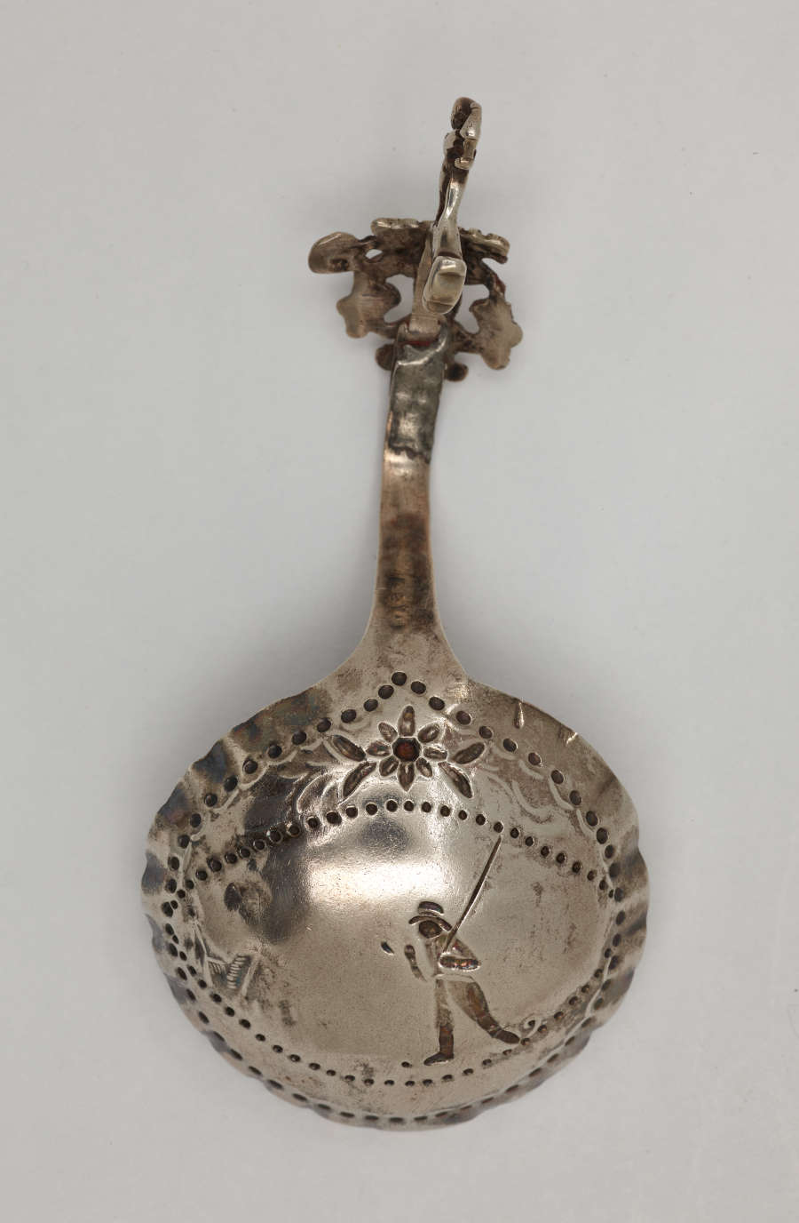  A silver caddy spoon with figurative and sculptural elements.