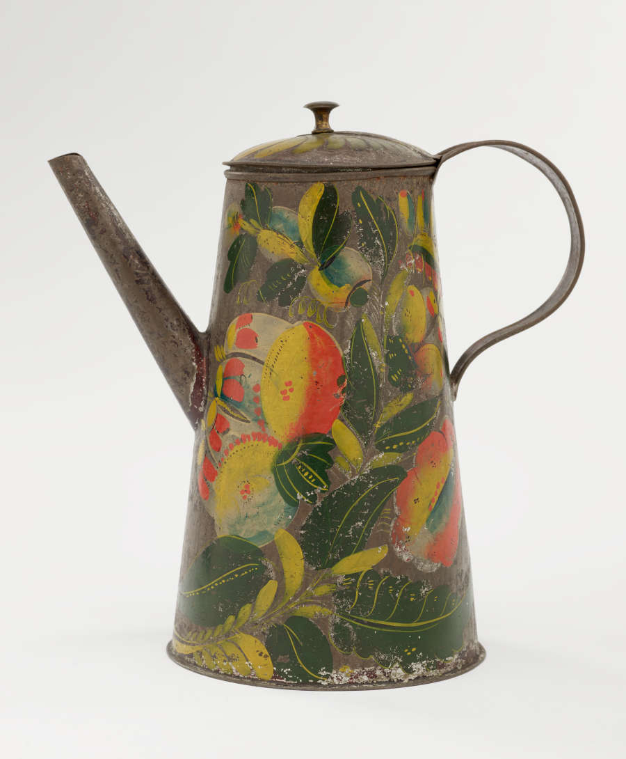 A tin coffee pot with painted orange, yellow, and green floral decorations.