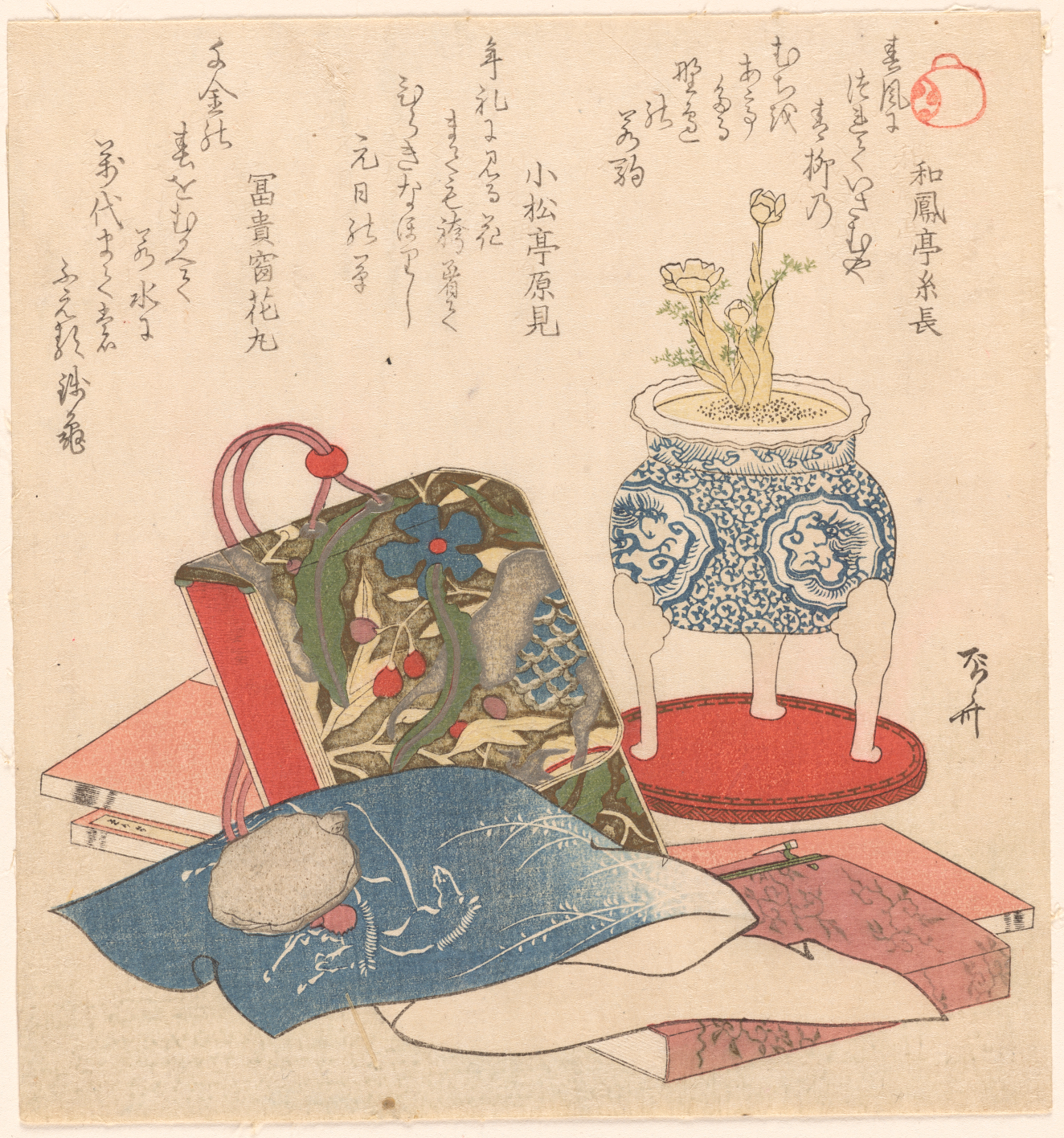 A still life with a patterned pouch, books, and a white and blue porcelain planter of flowers beneath columns of calligraphy.