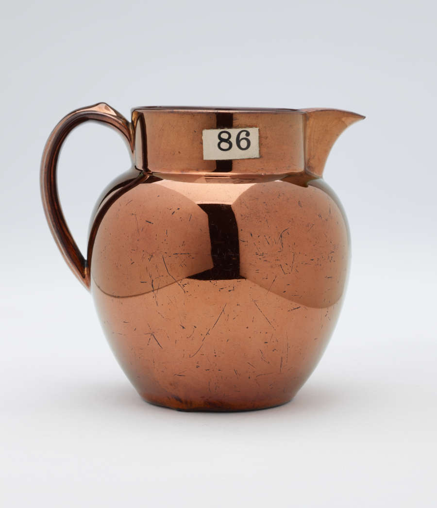 A bronze-colored jug.
