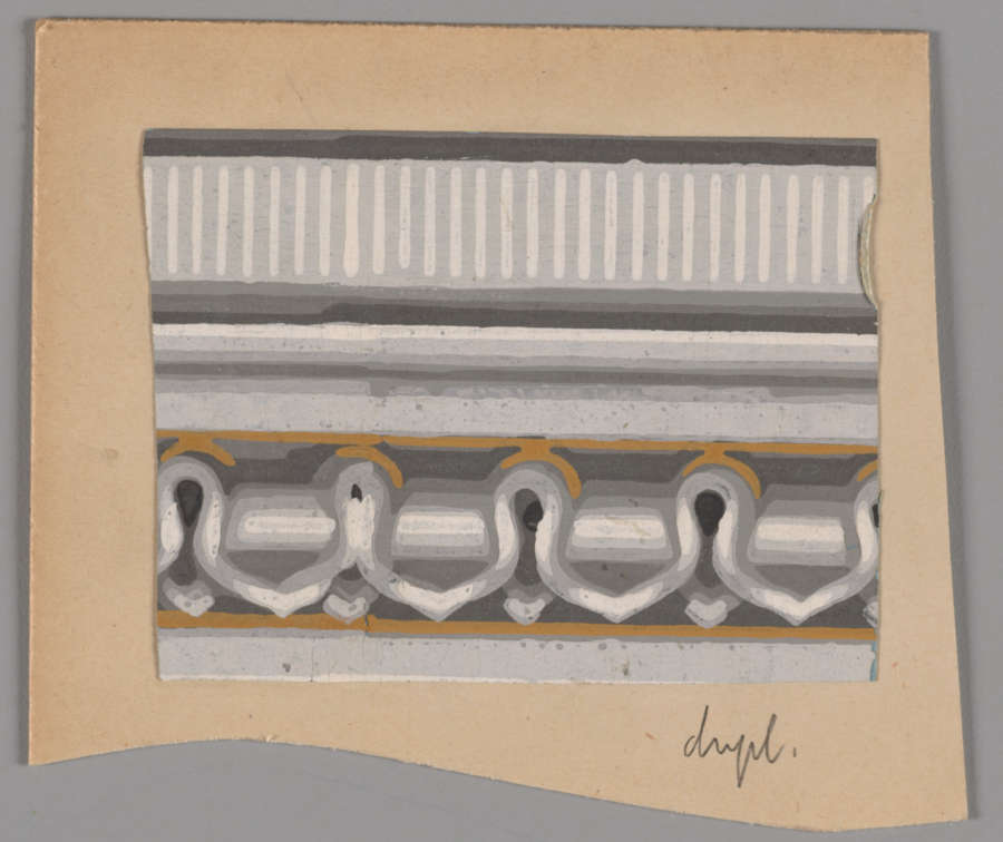 Paper cutout on a gray backdrop with a rectangular decorative design featuring a pattern of ornate shaded arches with gold accents below repeating vertical stripes.