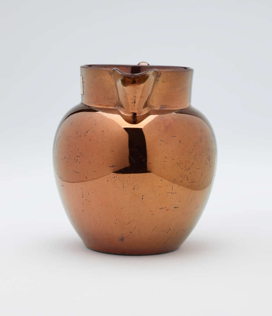 A bronze-colored jug.
