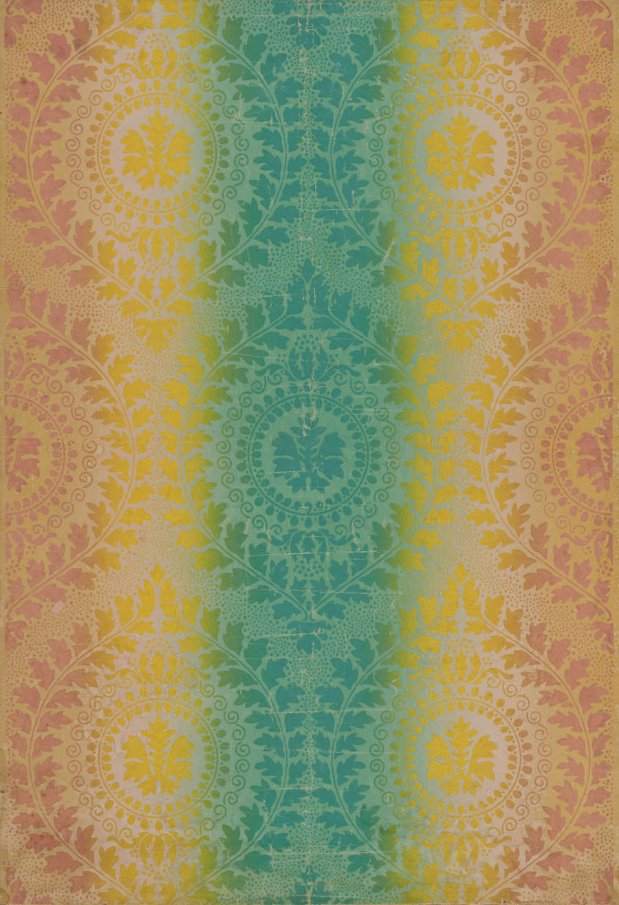 Wallpaper featuring detailed mandalas made of leaf and foliage designs that transition from a muted orange, to sunny yellow, to a cool teal at the center.