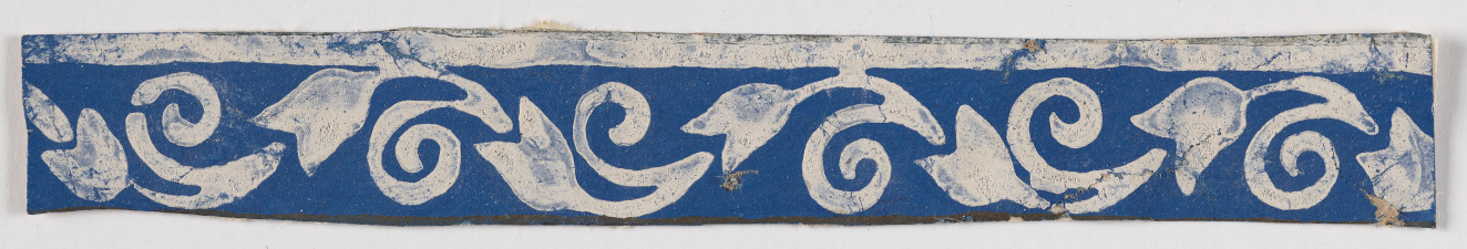 Horizontal blue decorative strip on a light background. Features white flowers and spiraling stem designs flowing to the left in repeat below a white stripe.