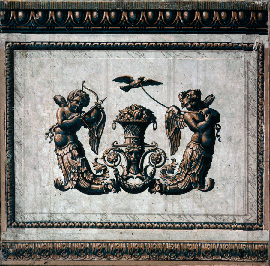 Symmetrical composition with playful winged cherubs surrounding an abundant vase. One of the cherubs holds rope tied to a bird, while the other is aiming an arrow at it.