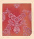 Wallpaper fragment of pale pink floral designs arranged symmetrically on a yellowing, red background.