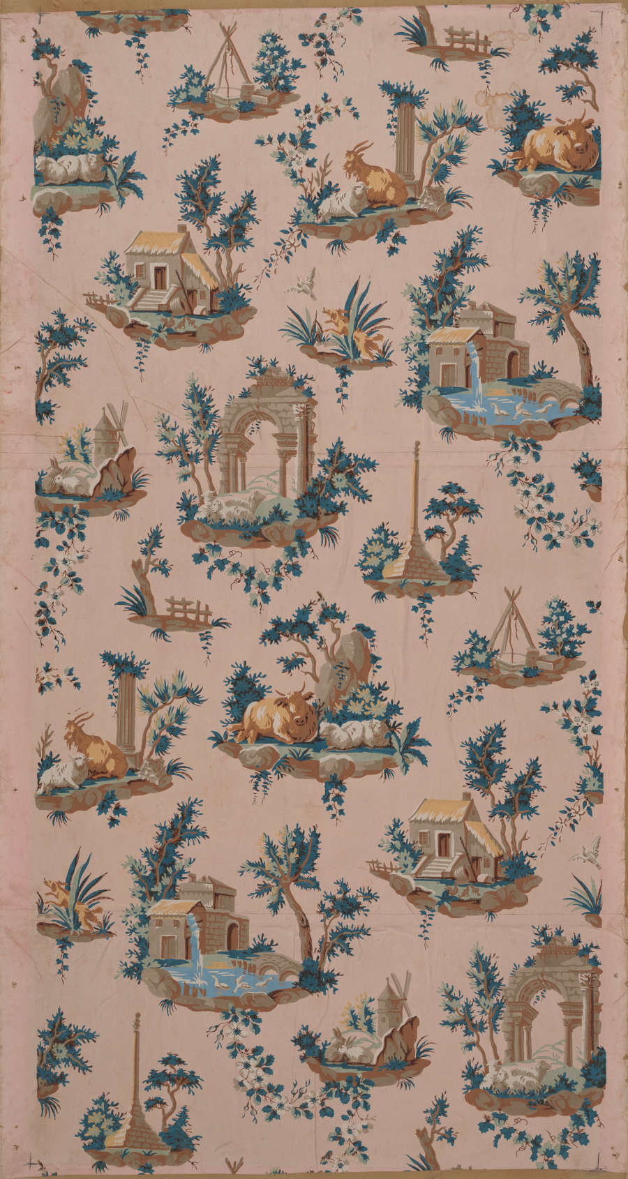 Tall panel of vintage wallpaper featuring a diagonal pattern of bucolic pastoral and architectural scenes amidst lush blue florals on a pale pink background.