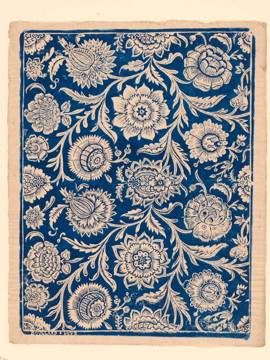 Vintage repetitive wallpaper sample depicting a dense, ornate, blue and cream pattern showcasing paisleys and intricate stylized floral motifs on a rich tan-toned base.