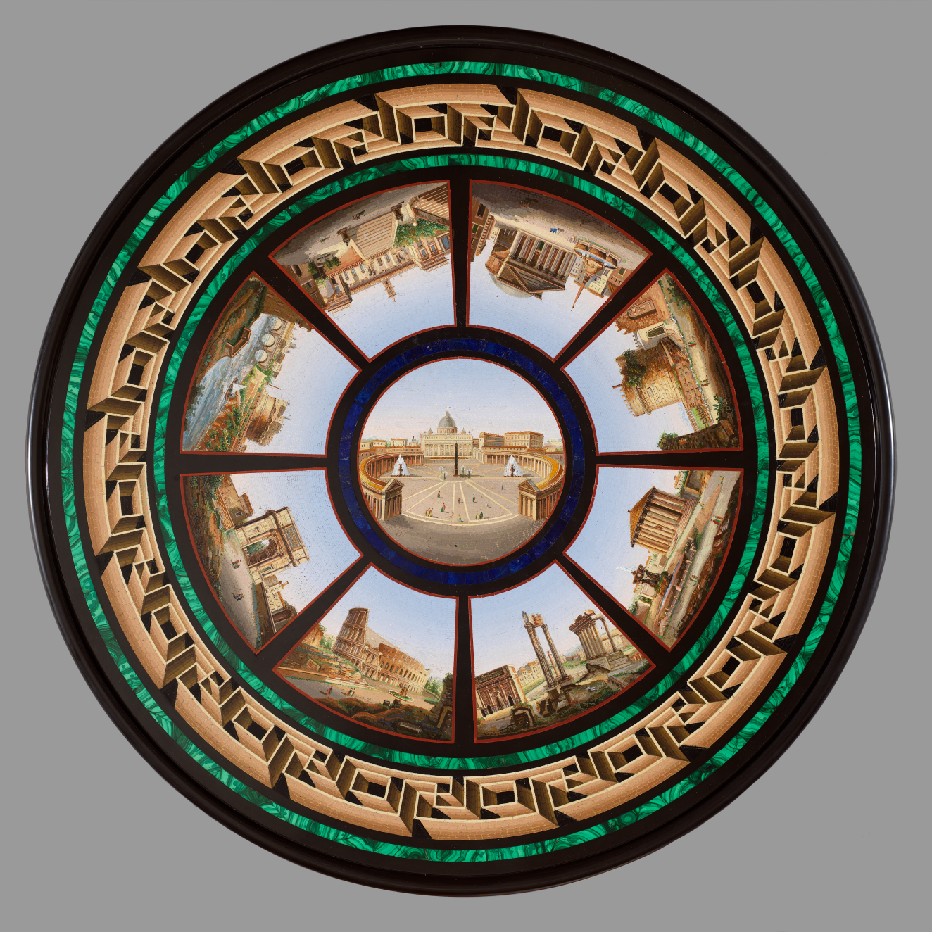 Circular surface of a central image surrounded by eight detailed scenes of landmark buildings in radiating panels, encircled by bright green and gold geometric mosaic patterns. 